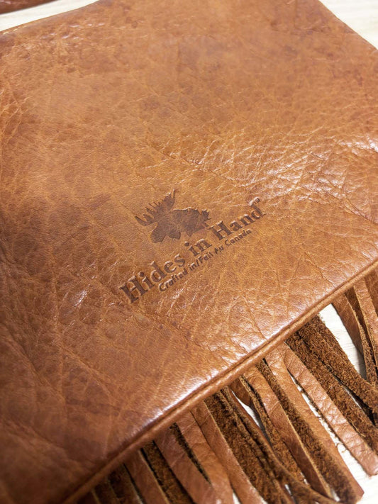hides in hand fringe leather crossbody bag + tassel charm