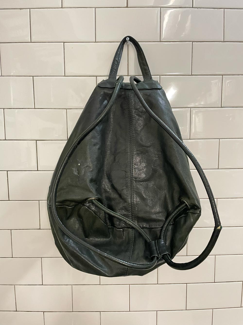 vintage sun-faded green leather backpack