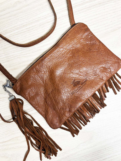 hides in hand fringe leather crossbody bag + tassel charm