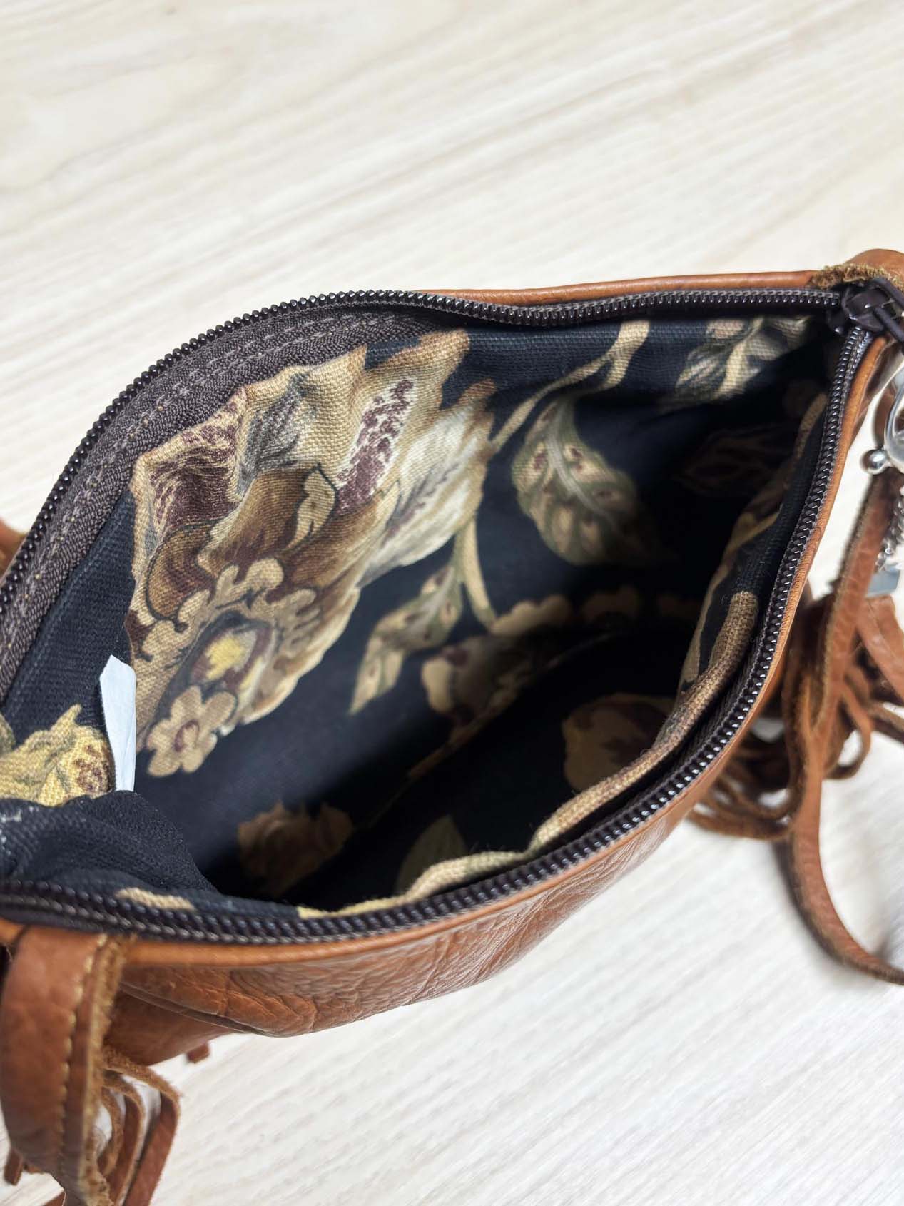 hides in hand fringe leather crossbody bag + tassel charm