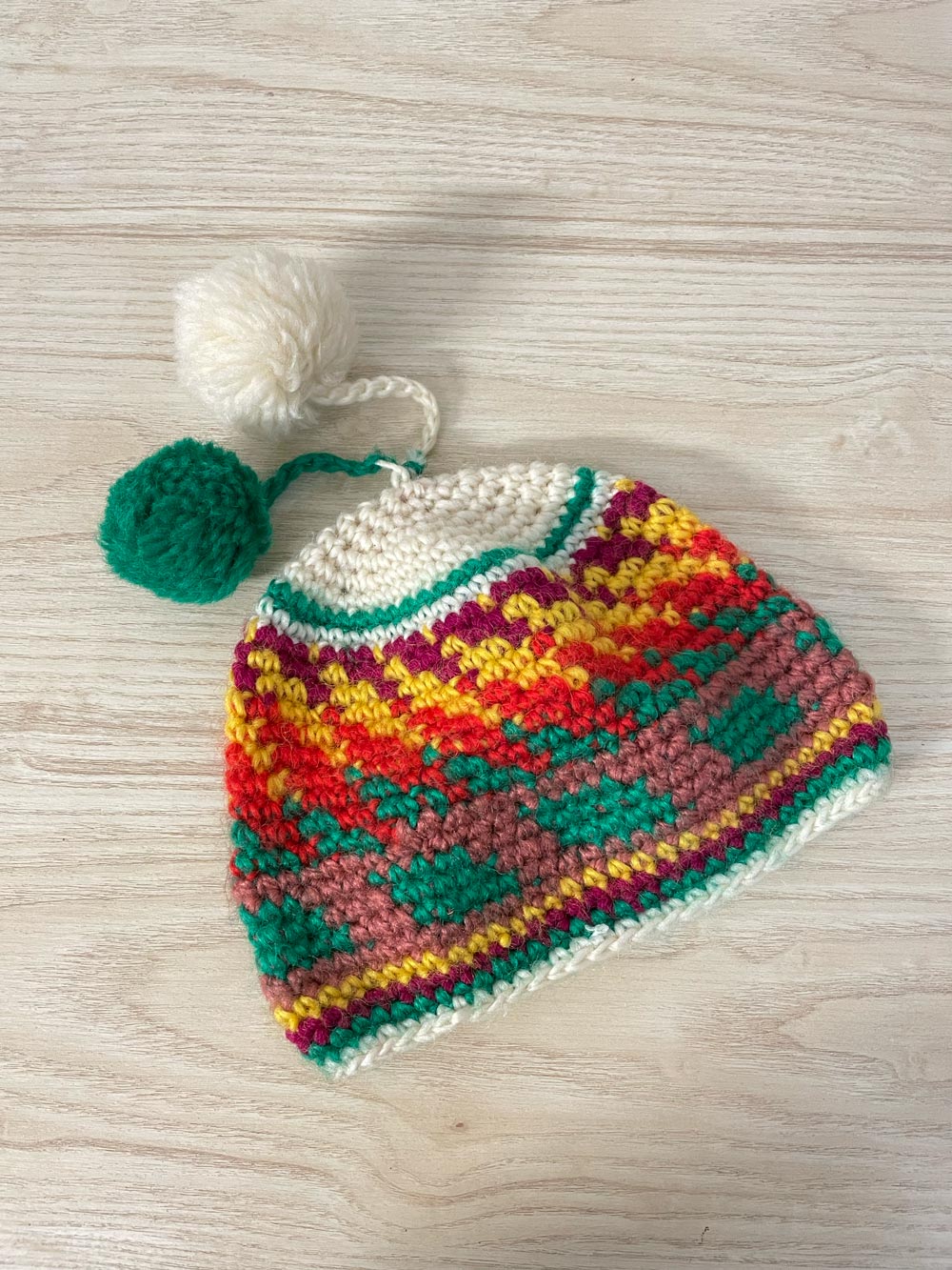 hand-knit rainbow pom toque