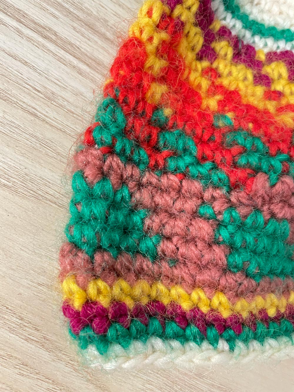 hand-knit rainbow pom toque