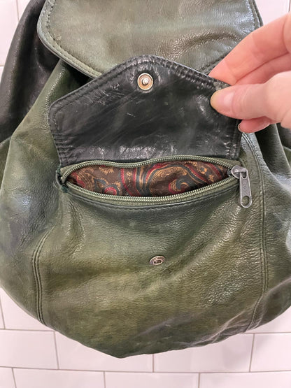 vintage sun-faded green leather backpack