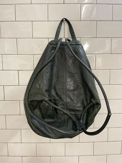 vintage sun-faded green leather backpack