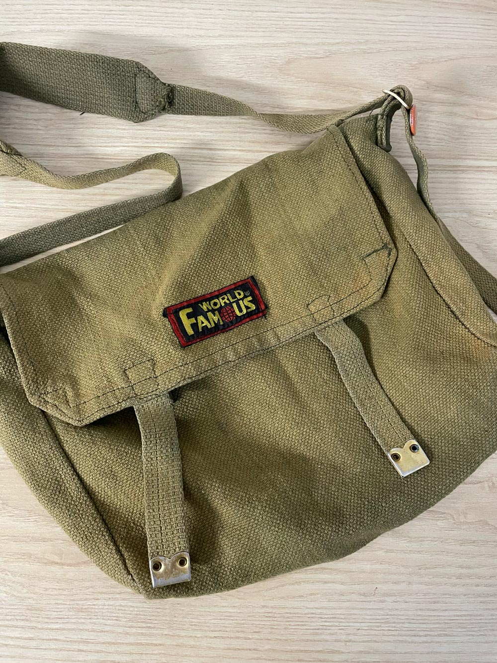 world famous faded messenger bag