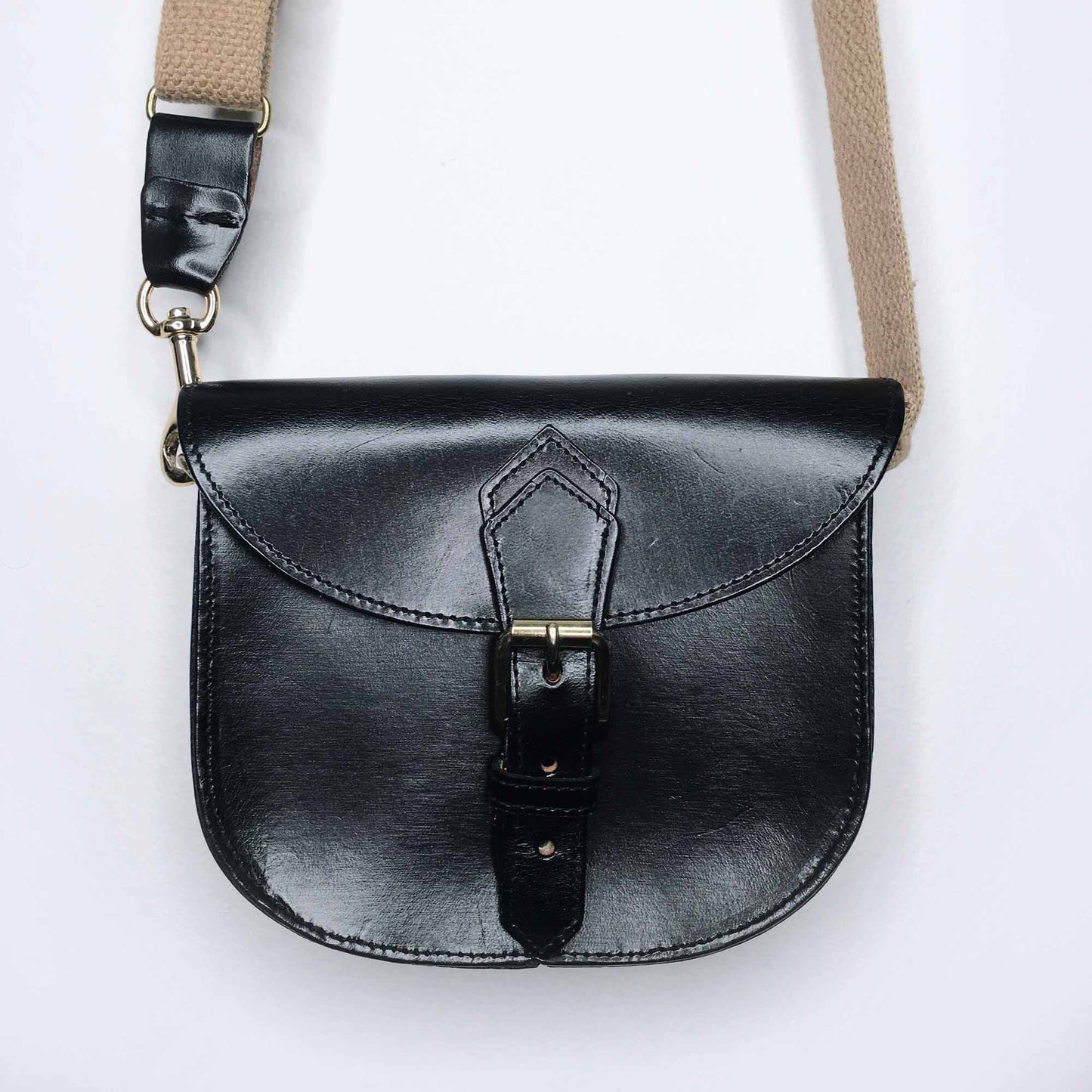 Mini leather saddle cross body bag with woven strap