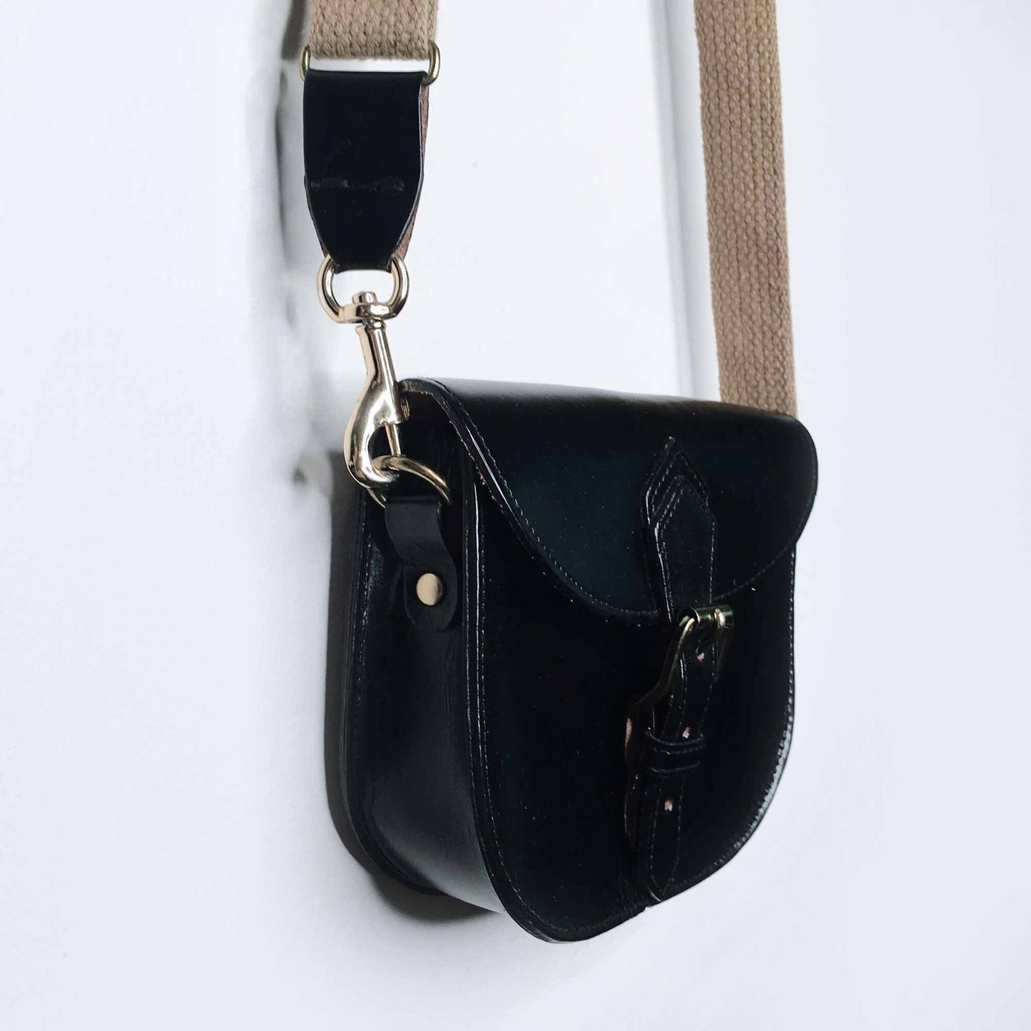 Mini leather saddle cross body bag with woven strap