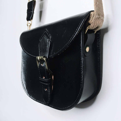 Mini leather saddle cross body bag with woven strap