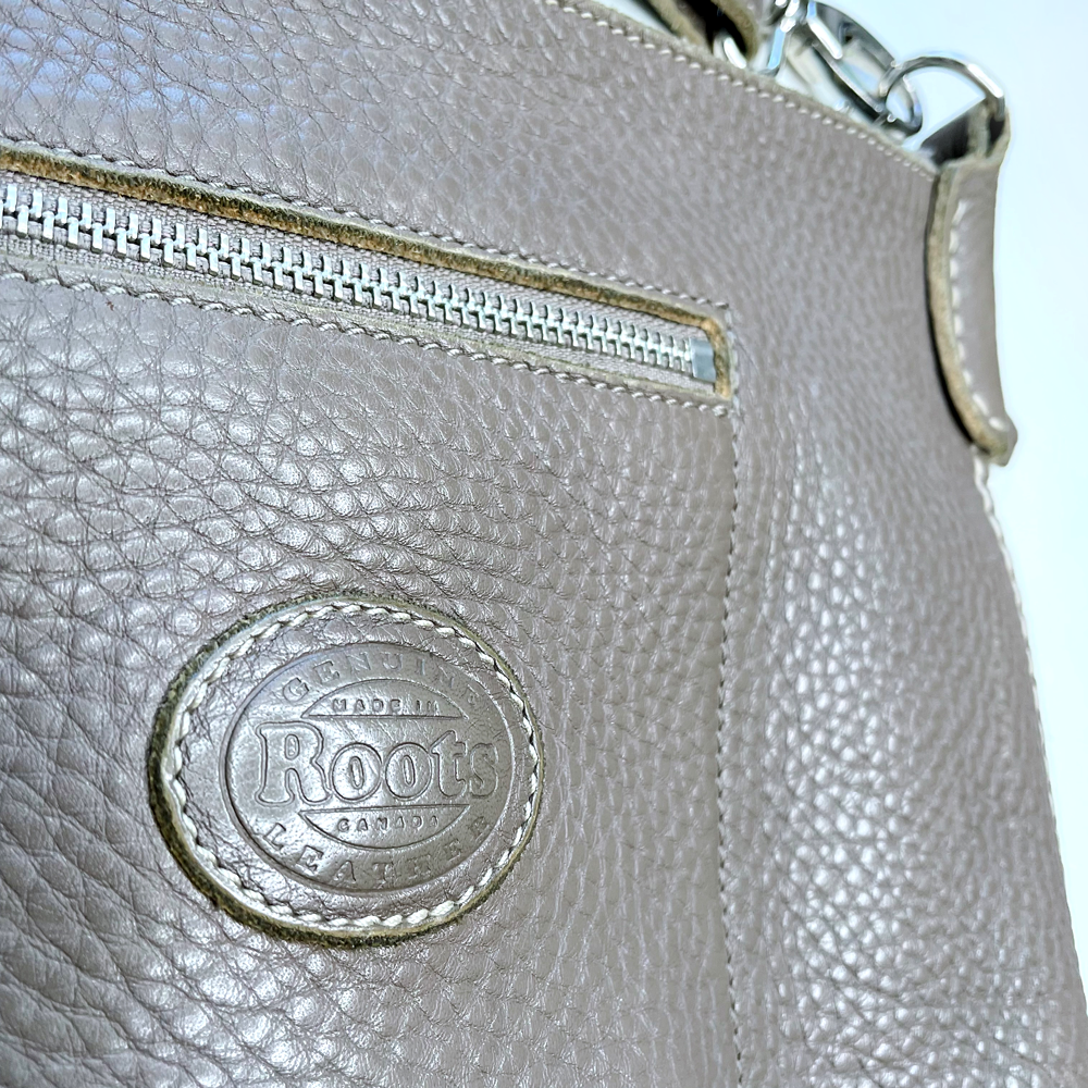 roots pebbled leather crossbody bag with front cargo pocket